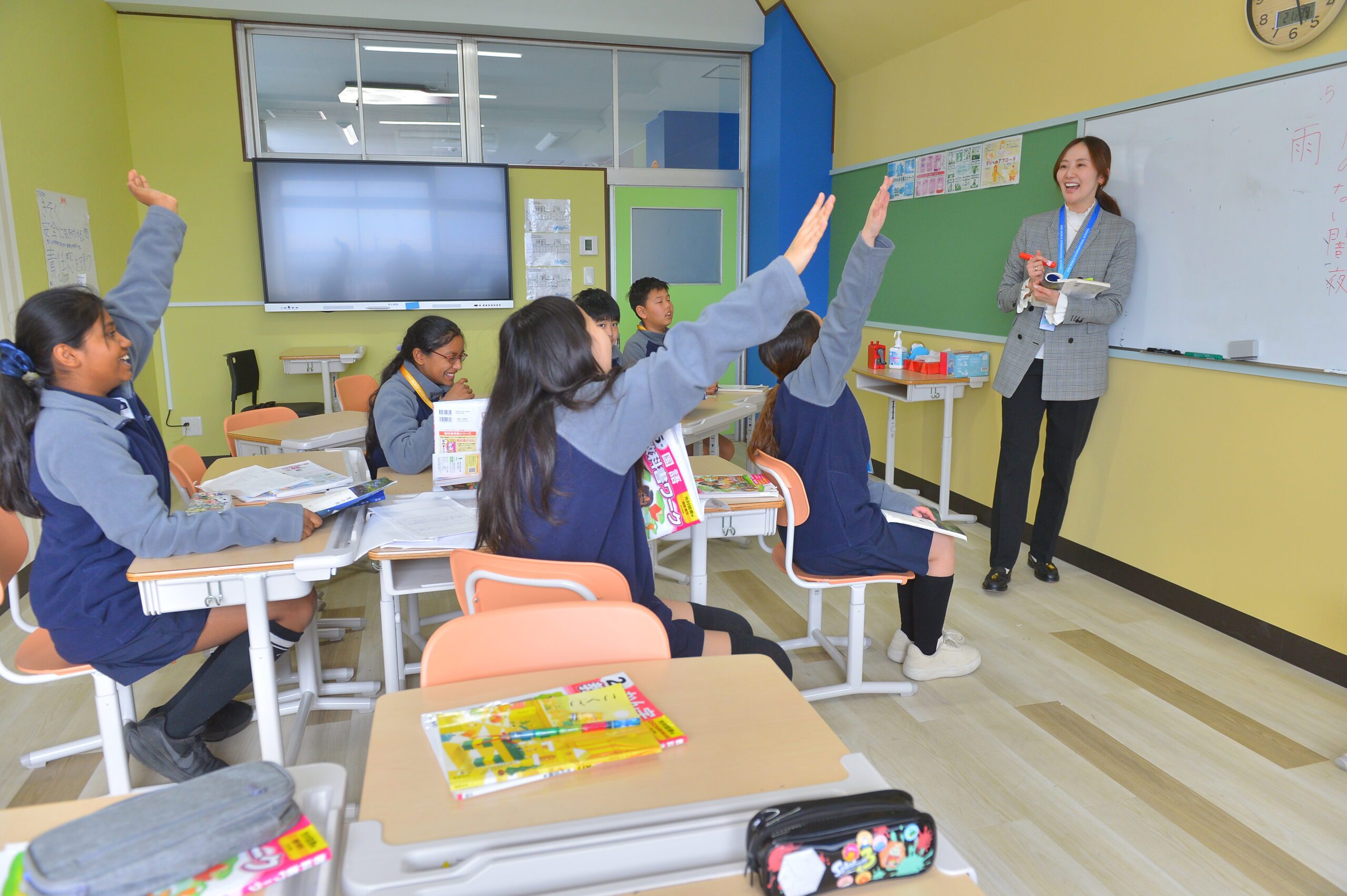 Students with hands up at One World International School Tsukuba