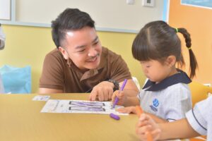 Early childhood student at One World International School Tsukuba gets assistance from the teacher in class